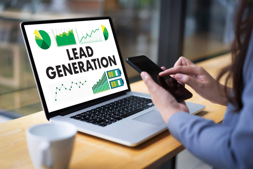 Person using smartphone near laptop with "Lead Generation" and digital marketing graphs.