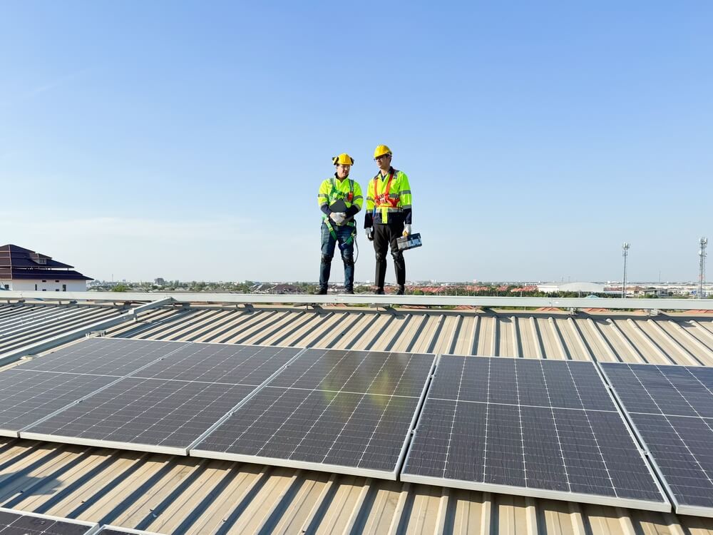 Two roofers on solar panels, ideal for SEO services and content marketing visuals.