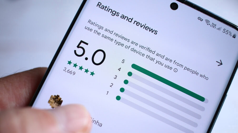 A smartphone shows a 5-star SEO services review, ideal for digital marketing agencies.