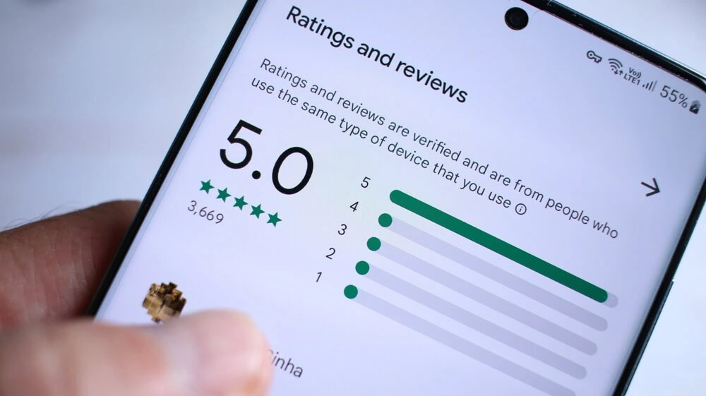 A smartphone shows a 5-star SEO services review, ideal for digital marketing agencies.
