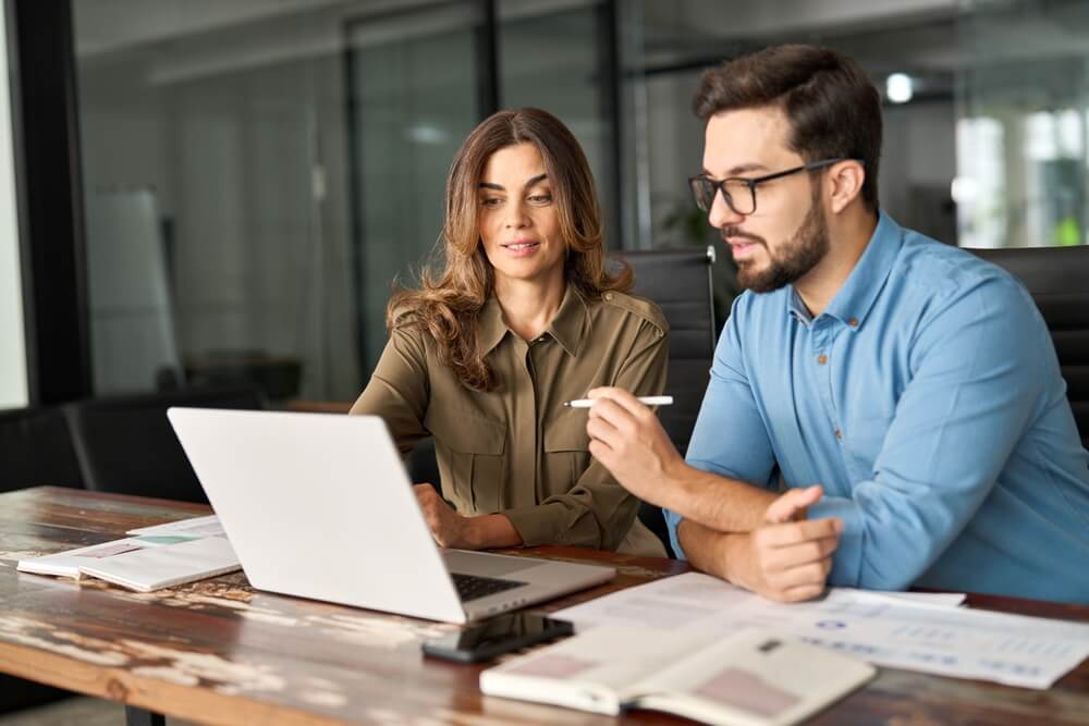 Two marketers at a digital marketing agency discuss SEO services and content strategy.