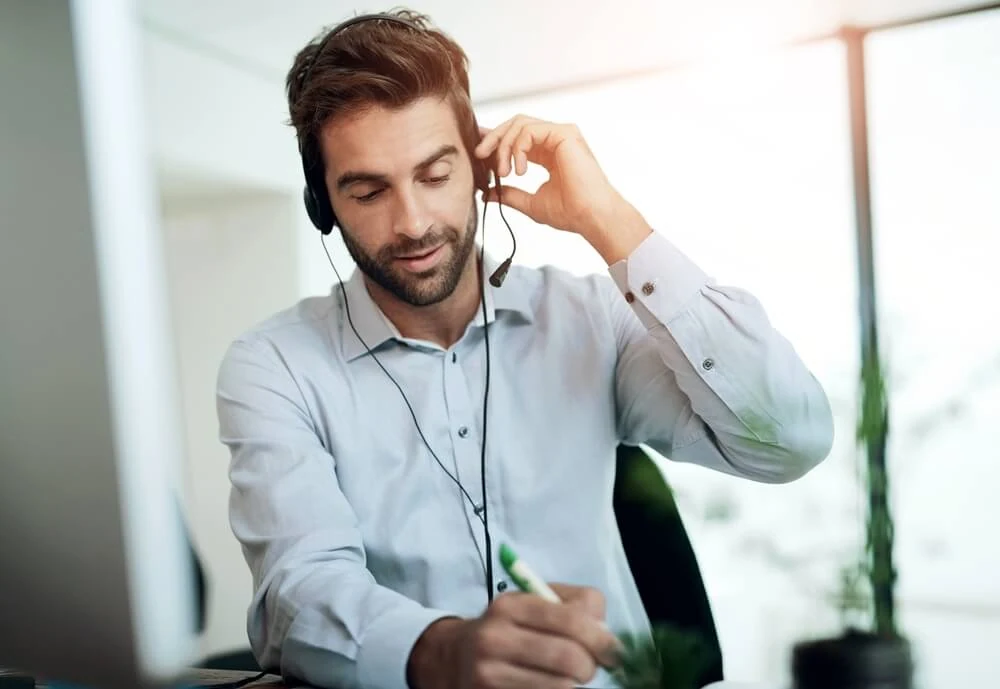 A digital marketing agency expert reviews SEO services at a desk with a headset.