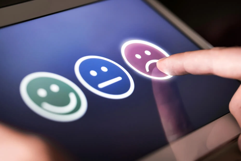 A user selects a sad face on a feedback survey for a digital marketing agency.
