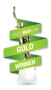 A gold MarCom Award trophy with green ribbons, 2023 winner for digital marketing agency excellence.