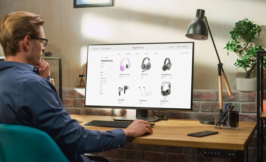 A person at a desk researches SEO services and content marketing on a computer.