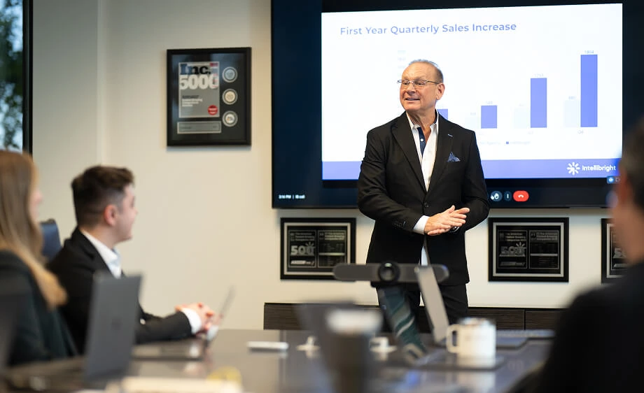 A presenter shares SEO, content marketing, and paid media results in an agency meeting.