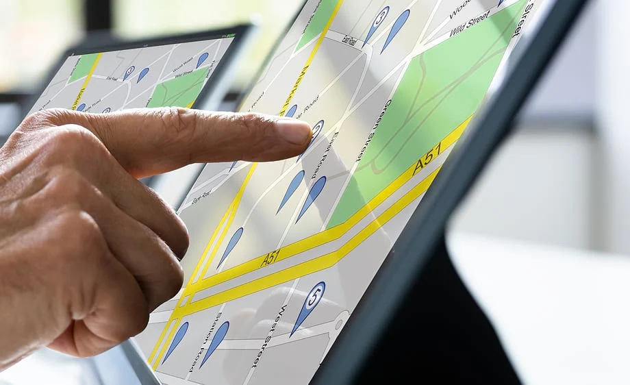 A hand selects a spot on a touchscreen map highlighting SEO and digital marketing tools.