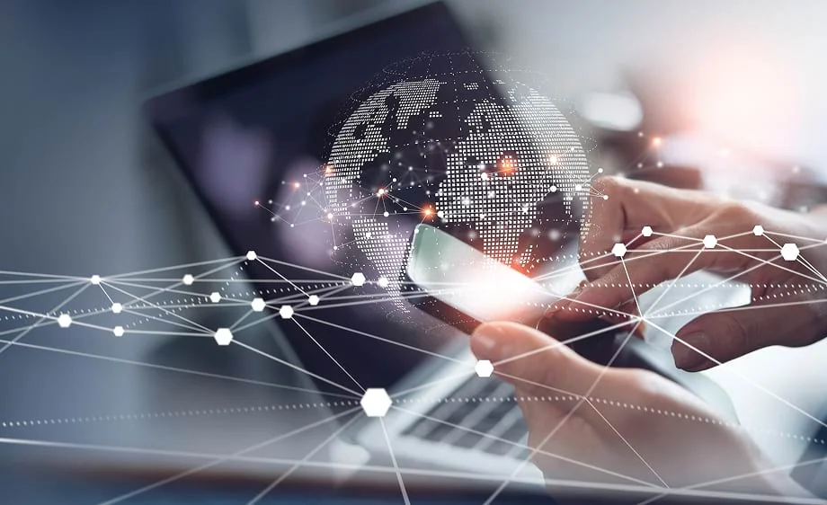 Person on smartphone with laptop, depicting SEO, content marketing, and web development.