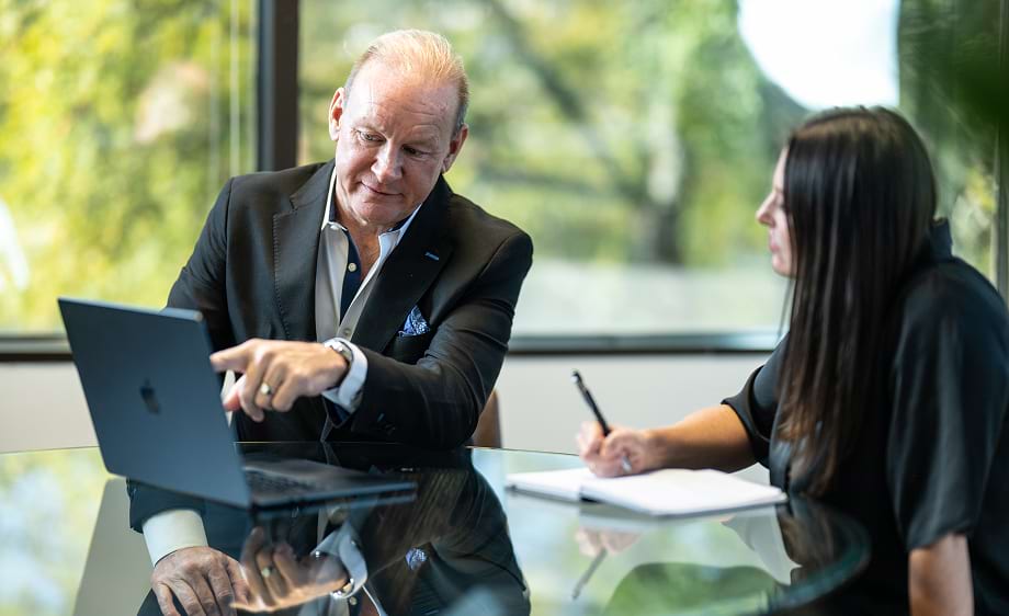 Two marketers discuss SEO strategies at a digital marketing agency office.