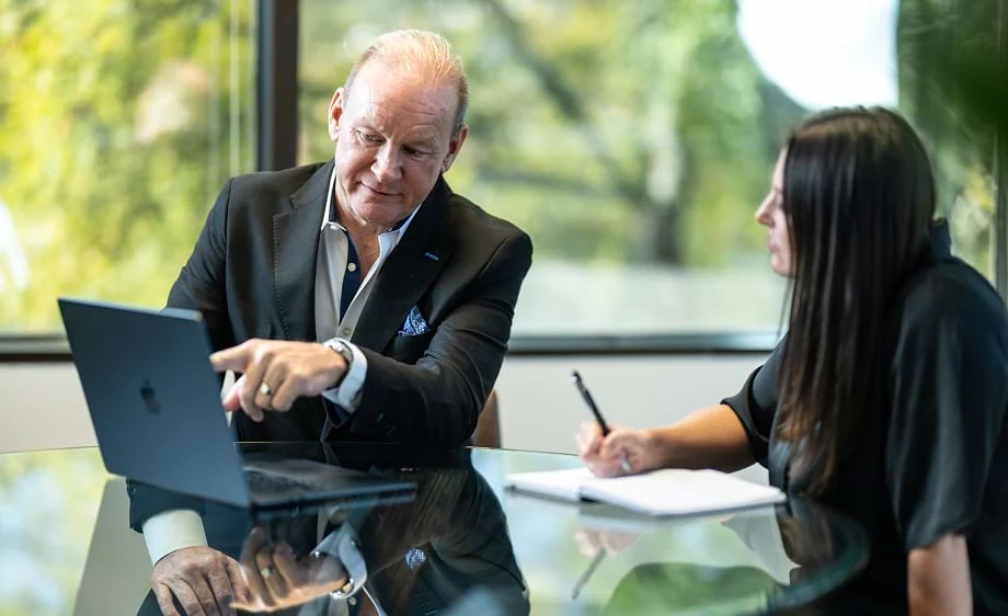 Two marketers discuss SEO strategies at a digital marketing agency office.