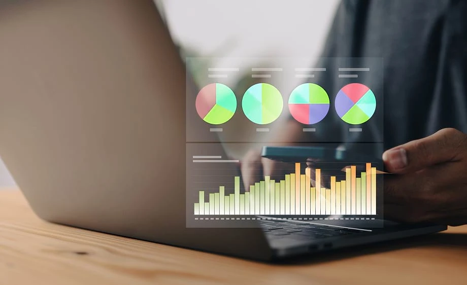 A person analyzes SEO and social media metrics on a laptop for a digital marketing agency.