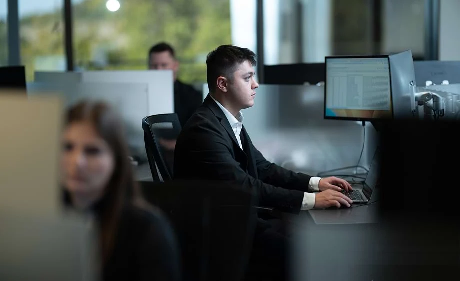 A digital marketing agency team works on SEO, content, and paid media at desks.