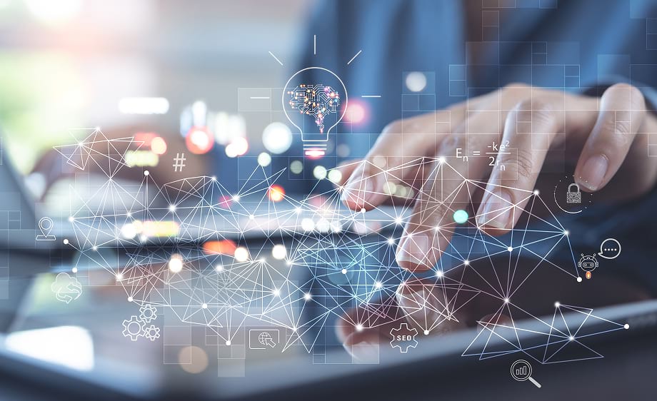 A person uses a tablet and laptop with graphics symbolizing digital marketing agency, SEO services, social media marketing, web development, and paid media.