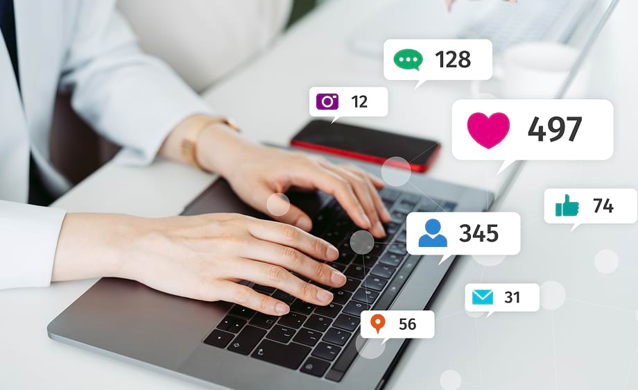 A user at a laptop with social media icons, symbolizing digital marketing services.
