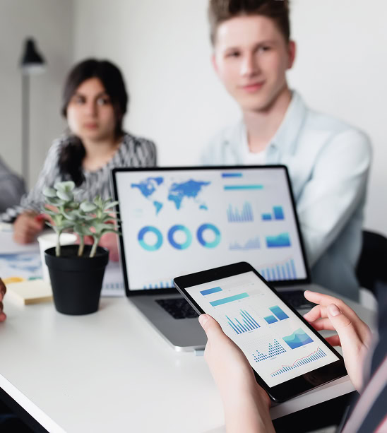 Digital marketing agency team reviews SEO services and social media analytics on devices.