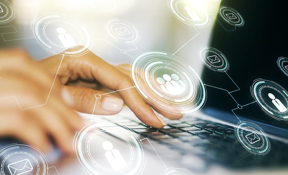 Hand typing on laptop with social media marketing and SEO icons for a digital marketing agency.