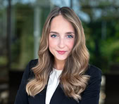 A digital marketing expert in business attire stands outdoors, ready to discuss SEO services.