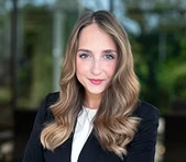 A digital marketing expert in business attire stands outdoors, ready to discuss SEO services.
