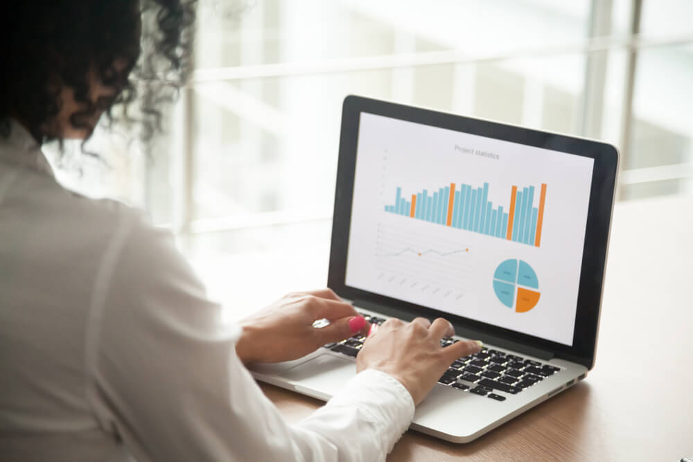 Digital marketing agency expert reviews analytics on laptop for SEO and content marketing.