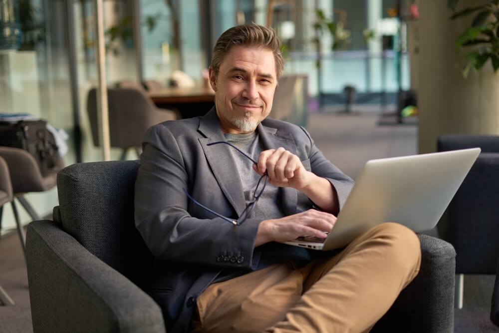 A digital marketing strategist reviews SEO and content marketing reports on a laptop.