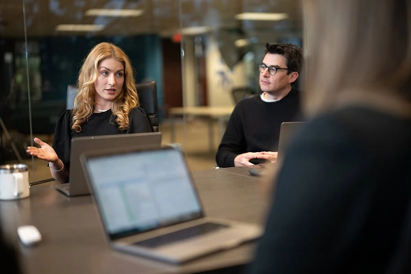 Three team members discuss SEO, social media, and web development strategies.