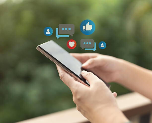 A person uses a smartphone with social media marketing and SEO service icons.