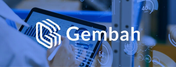 A person uses a tablet with graphs, Gembah logo, and digital marketing agency analytics.