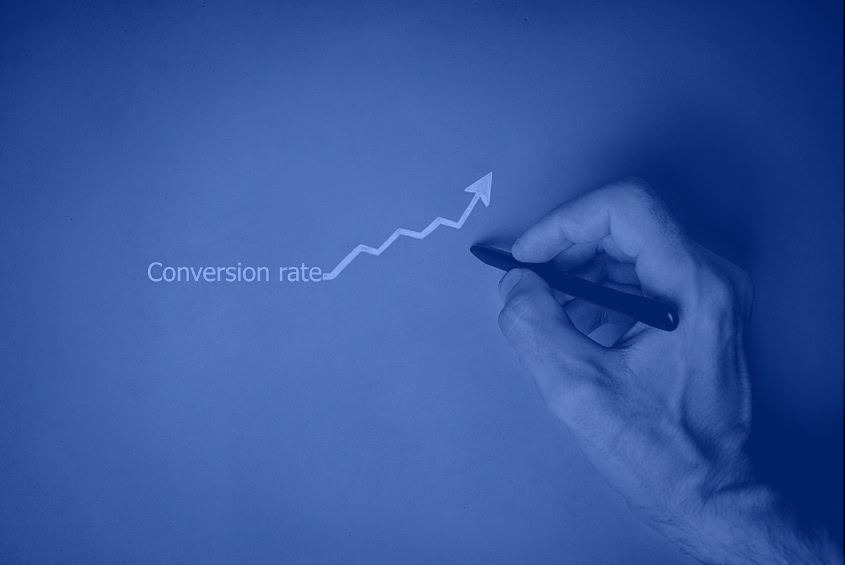 A hand sketches an upward arrow by "Conversion rate" for a digital marketing agency.