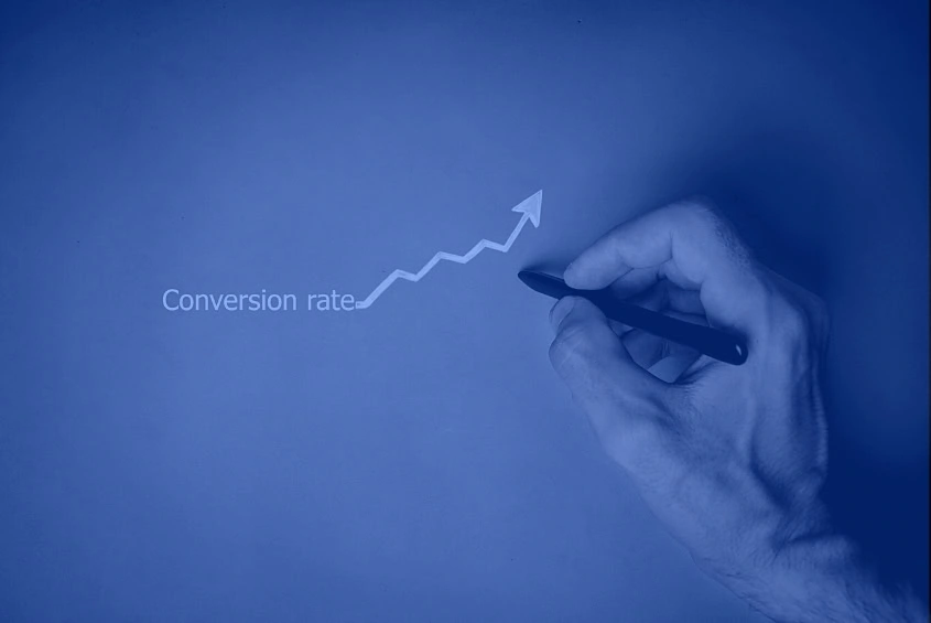 A hand sketches an upward arrow by "Conversion rate" for a digital marketing agency.