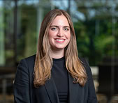 A smiling woman in business attire represents a digital marketing agency team.