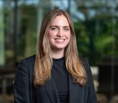 A smiling woman in business attire represents a digital marketing agency team.