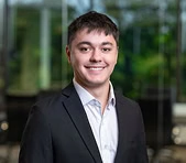 Young man in business attire at a digital marketing agency office with greenery.