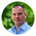 Kevin Benner, digital marketing agency expert, stands outdoors in a light blue shirt.