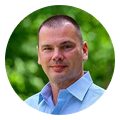 Kevin Benner, digital marketing agency expert, stands outdoors in a light blue shirt.