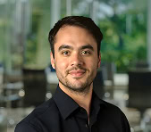 A digital marketing agency expert poses indoors with a blurred office background.