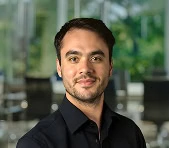 A digital marketing agency expert poses indoors with a blurred office background.