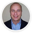Portrait of a smiling man in business attire, digital marketing agency executive.