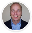 Portrait of a smiling man in business attire, digital marketing agency executive.
