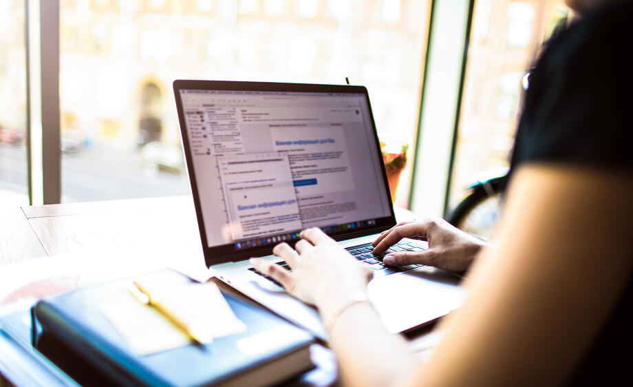 Digital marketing agency professional writing SEO and content marketing strategies on laptop.