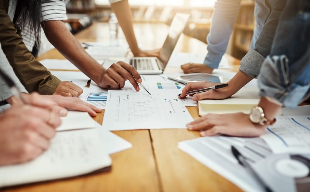 Digital marketing agency team discusses SEO, content, and social media strategies.