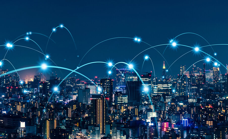 City skyline at night with digital lines representing SEO and social media marketing.