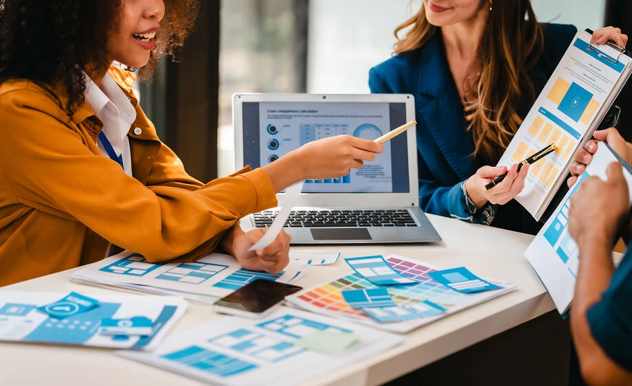 Digital marketing agency team analyzes SEO reports, web design, and paid media data.