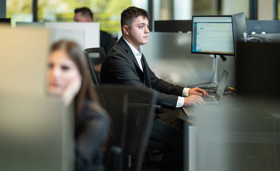 A man at a digital marketing agency desk manages SEO, web development, and content.