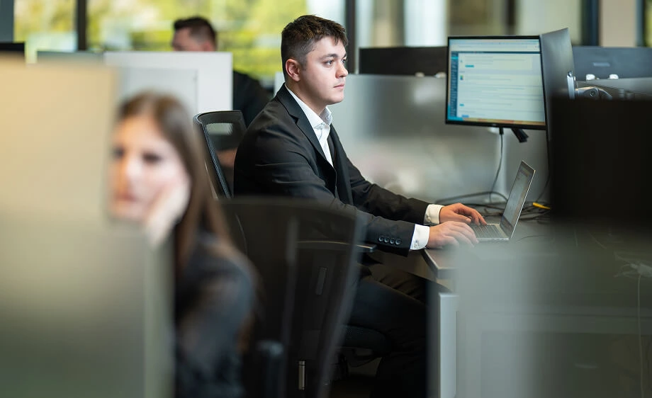 A man at a digital marketing agency desk manages SEO, web development, and content.