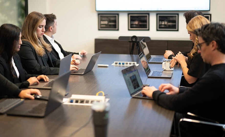 Digital marketing agency team discusses SEO, content marketing, and web development.