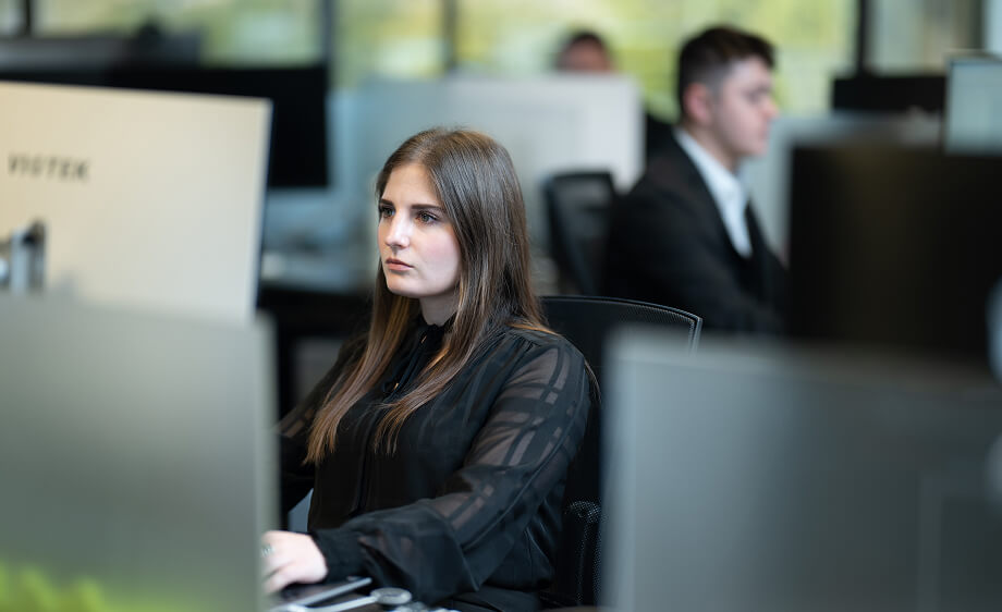 A digital marketing specialist manages social media campaigns at a marketing agency office.