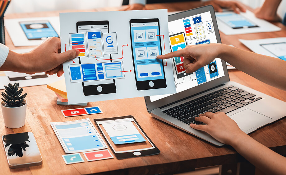 Marketers at a digital marketing agency review app wireframes for SEO and UX.