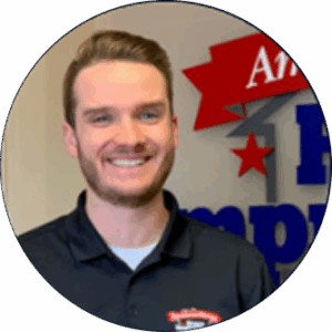Nick Rosynek, digital marketing agency expert, smiles before branded SEO services wall.