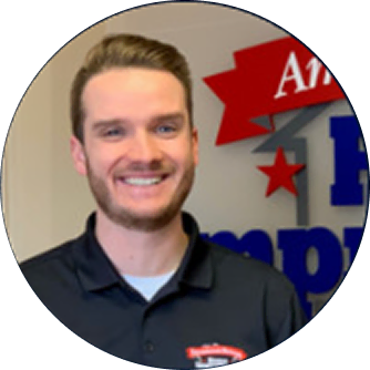 Nick Rosynek, digital marketing agency expert, smiles before branded SEO services wall.