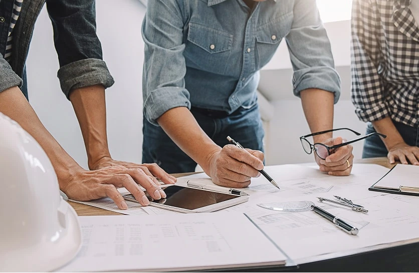 Digital marketing agency team reviews web development and SEO strategy plans together.